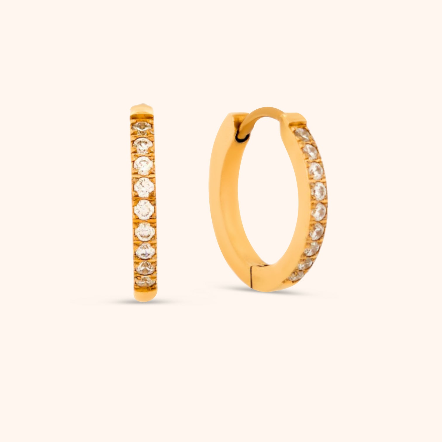 Close-up of 14k gold plated huggie earring with cubic zirconia stones, waterproof and hypoallergenic
